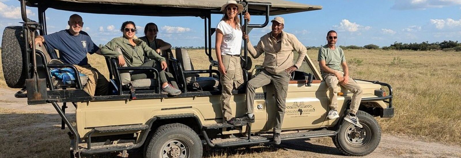 Guests on a safari vehicle going on a sheduled departure safari in Botswana.