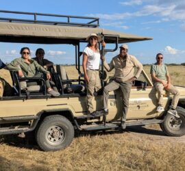 Guests on a safari vehicle going on a sheduled departure safari in Botswana.